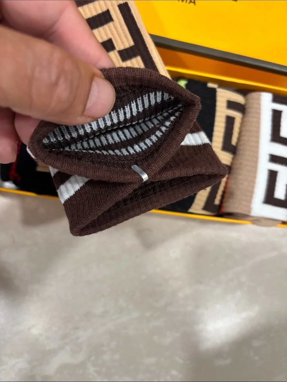 Fendi Bold Yellow Logo Wall Plaque with five pair of socks